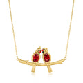 Gold branch bird necklace with two red cardinal charms and red gemstone eyes