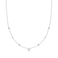 Sterling silver station necklace with round diamonds and blue sapphire accents