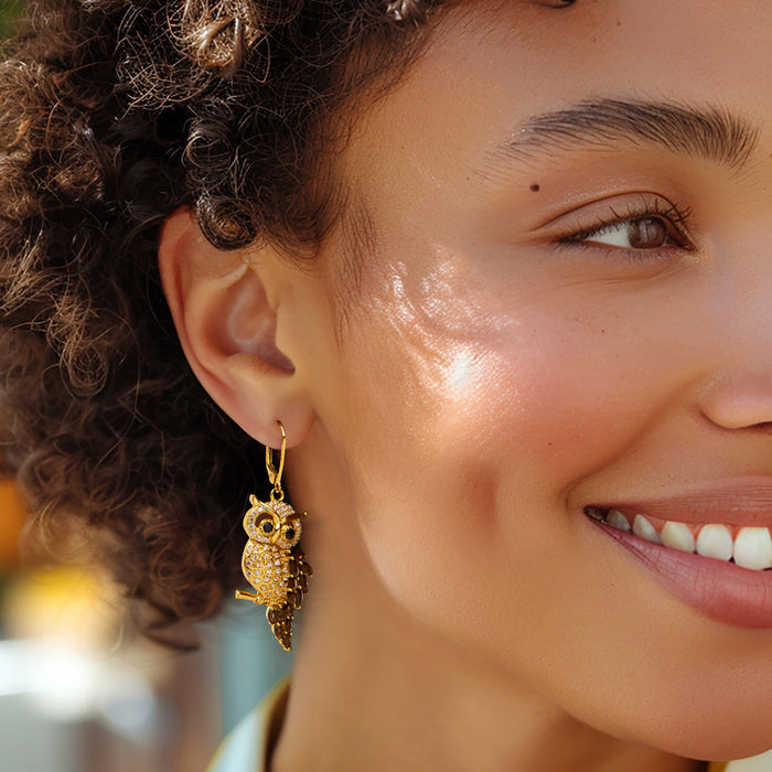 Gold owl drop earrings with pavé detail and leverback hooks