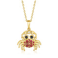 Gold crab pendant necklace with ruby-red and black stones, single diamond accent