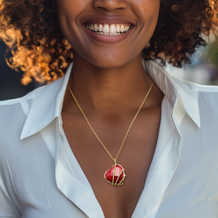 Ruby heart roped pendant necklace on gold chain worn at the neckline