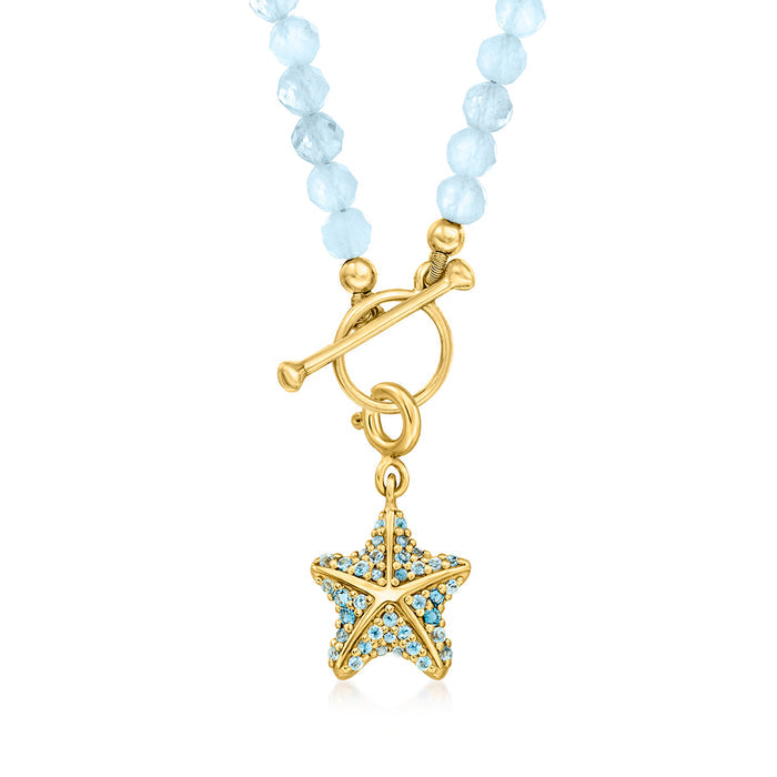 Aquamarine bead charm necklace with gold toggle and star charm pendant with blue stones.