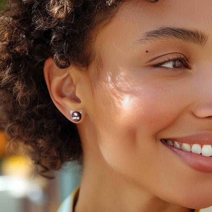 Cat stud earrings on model: dark pearl with diamond face, sterling silver posts