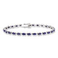 Sterling silver tennis bracelet with blue oval sapphires and diamond accents