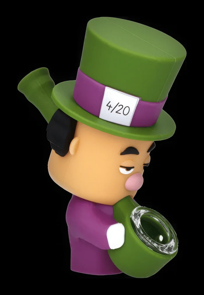Angled close-up of the Daily High Club Mad Hatter Silipipe figurine with a green top hat, purple band marked "4/20," and a green bowl in its mouth