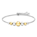 Sterling silver bolo bracelet with gold-and-silver round graduated beads, sliding clasp