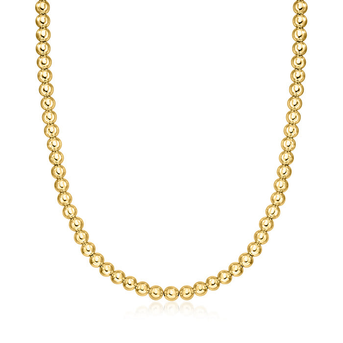 Gold bead necklace with small round beads in a continuous chain.