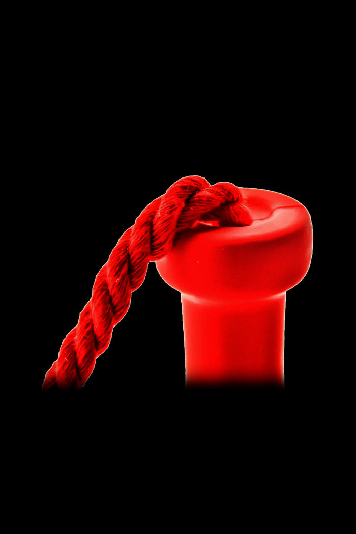 Red silicone carb cap for cannabis concentrates, with a woven rope attached.