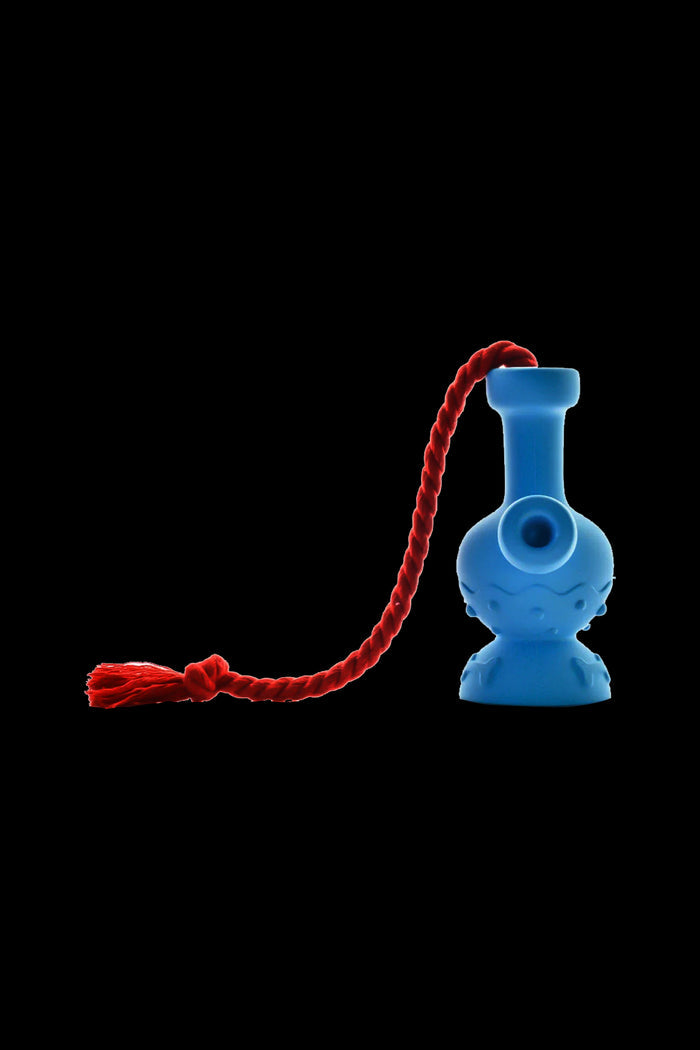 Blue glass oil rig with a red twisted lanyard against a black background.
