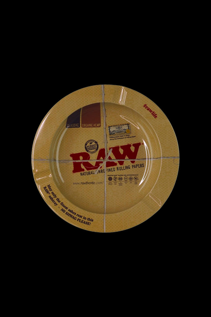 A circular package of RAW Natural Rolling Papers against a black background. <start_of_image>