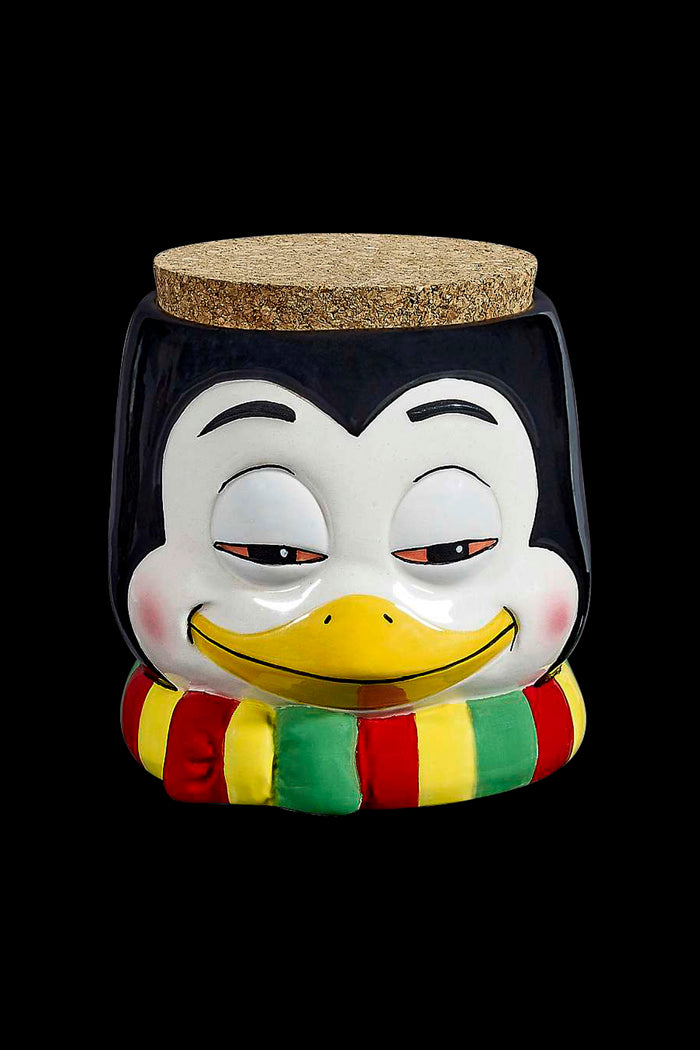 Vintage penguin-shaped ceramic jar with cork lid, likely used for cannabis storage.