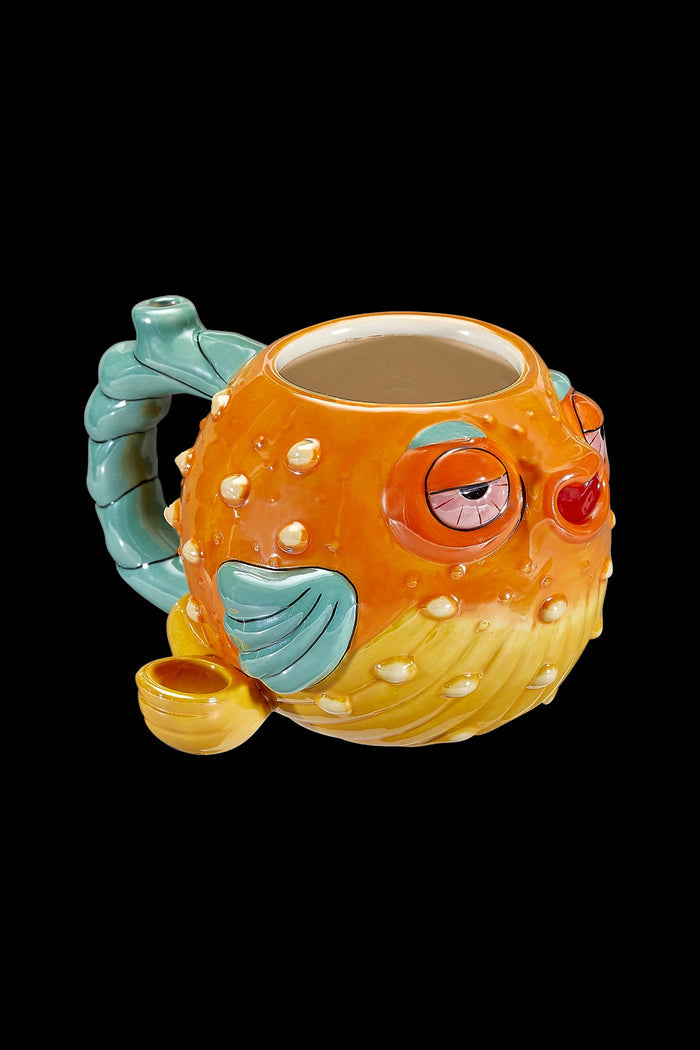 Ceramic pufferfish-shaped water pipe with turquoise accents and a closed eye detail.