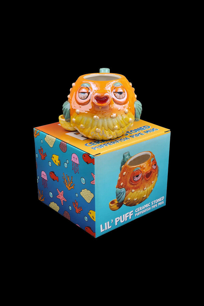 Orange pufferfish ceramic mug with packaging displaying “Lil’ Puff” and “stoned pufferfish pipe mug.”